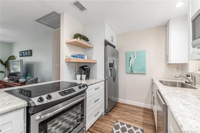 a kitchen with a stove and a sink