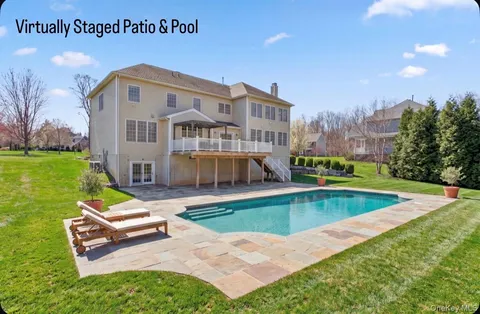 a kitchen with stainless steel appliances granite countertop a stove a sink a kitchen island a dining table and chairs