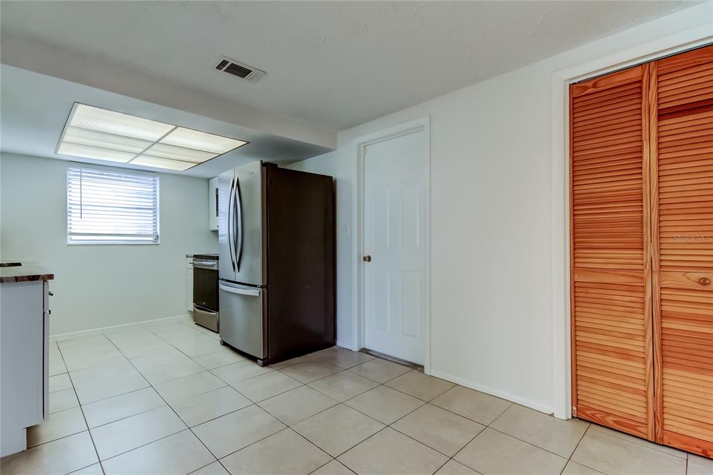 5753 Bantam Avenue New Port Richey, FL 34652 - Photo 15 of 47 a kitchen with a refrigerator and window