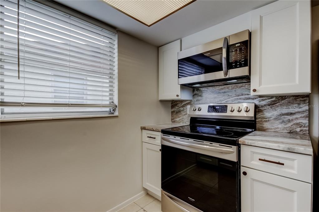 5753 Bantam Avenue New Port Richey, FL 34652 - Photo 19 of 47 a kitchen with a stove and a microwave