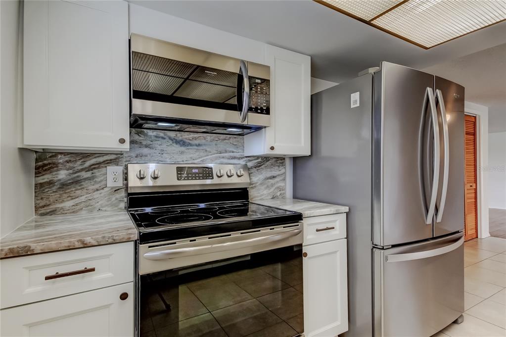 5753 Bantam Avenue New Port Richey, FL 34652 - Photo 20 of 47 a kitchen with a stove and a microwave