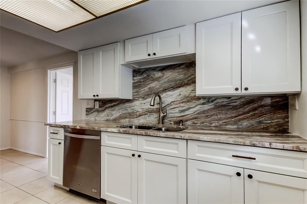 5753 Bantam Avenue New Port Richey, FL 34652 - Photo 21 of 47 a kitchen with granite countertop a sink and cabinets