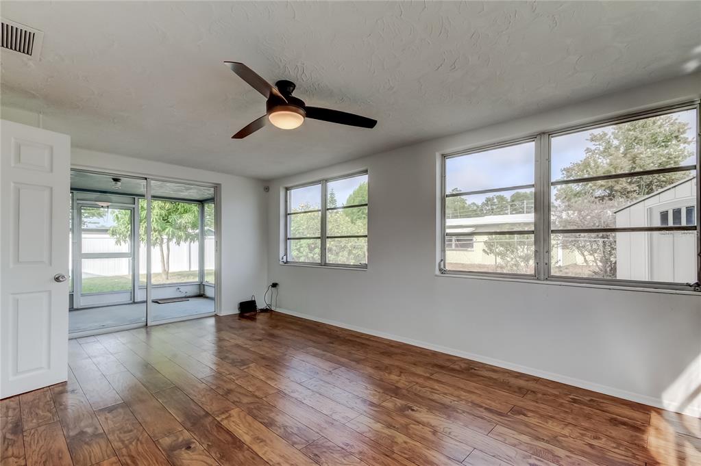 5753 Bantam Avenue New Port Richey, FL 34652 - Photo 25 of 47 a view of empty room with wooden floor and fan