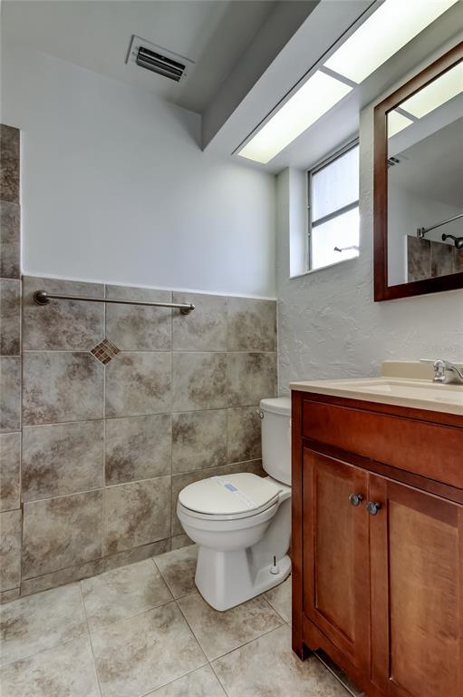 5753 Bantam Avenue New Port Richey, FL 34652 - Photo 34 of 47 a bathroom with a granite countertop toilet and a sink