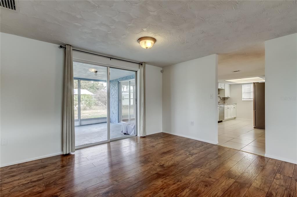 5753 Bantam Avenue New Port Richey, FL 34652 - Photo 8 of 47 wooden floor in an empty room with a window