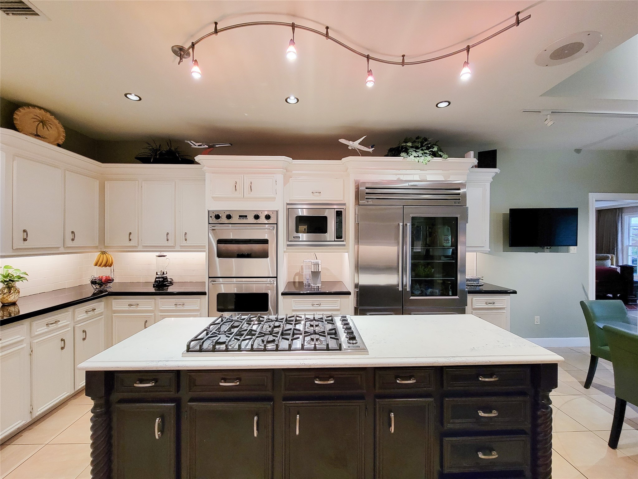 4401 Roseland Street Houston, TX 77006 - Photo 21 of 46 a kitchen with a sink stainless steel appliances and white cabinets