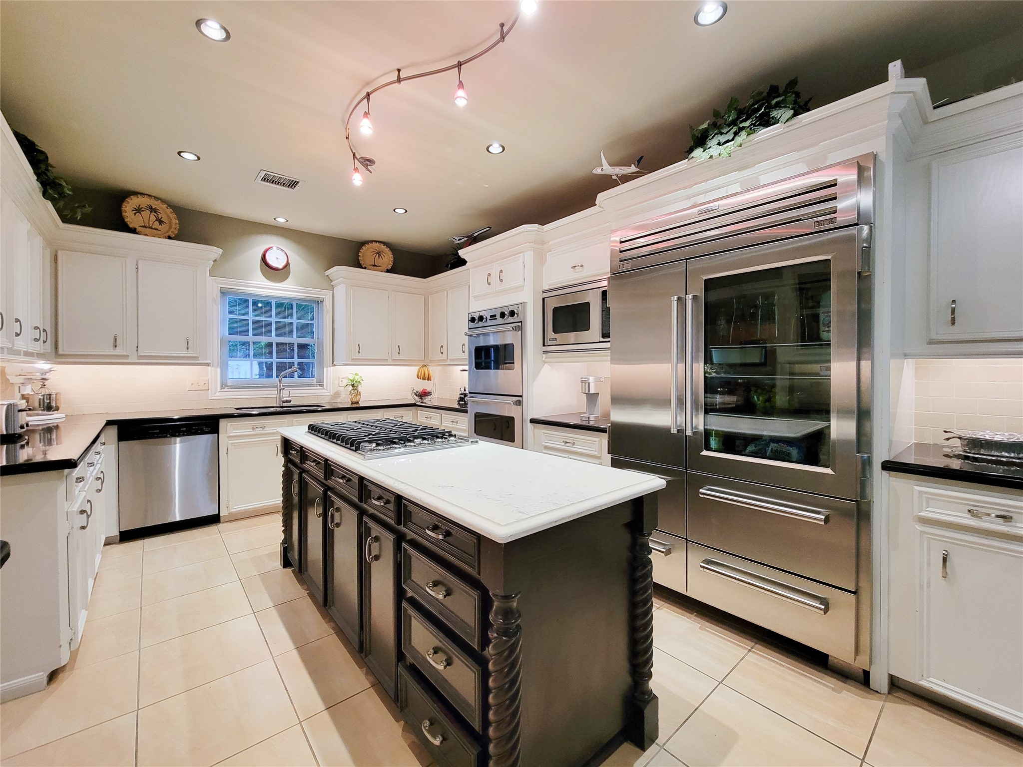 4401 Roseland Street Houston, TX 77006 - Photo 7 of 46 a kitchen with kitchen island a sink stainless steel appliances and cabinets