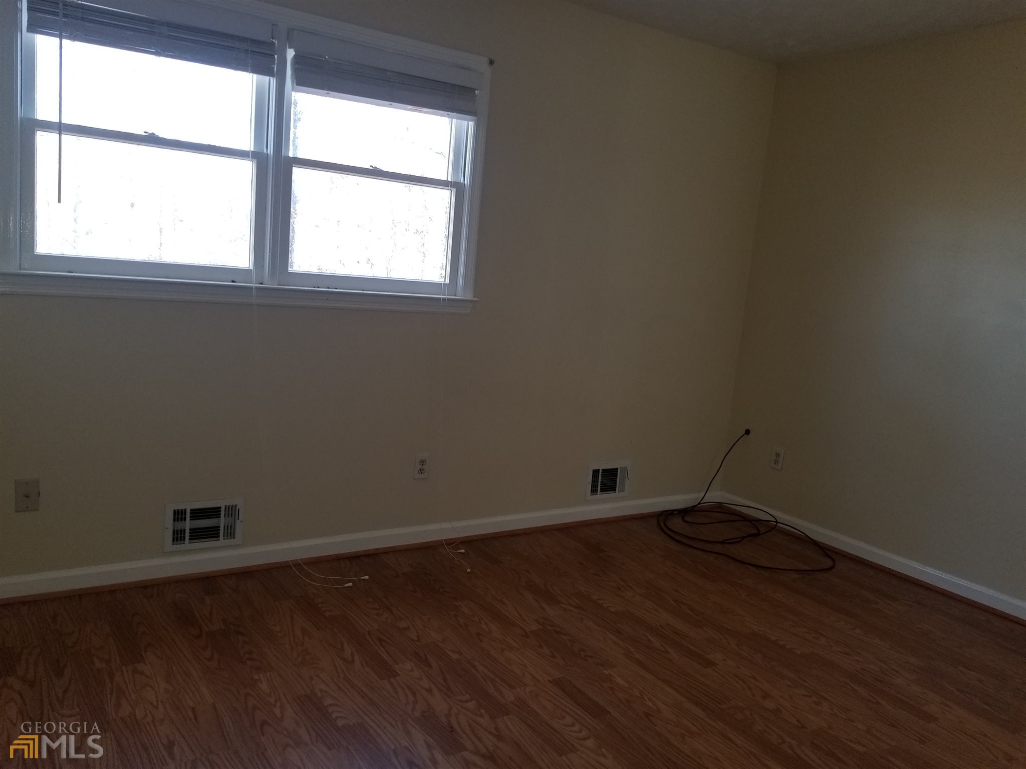163 Tommy Barnett Road Nicholson, GA 30565 - Photo 9 of 14 an empty room with wooden floor and windows
