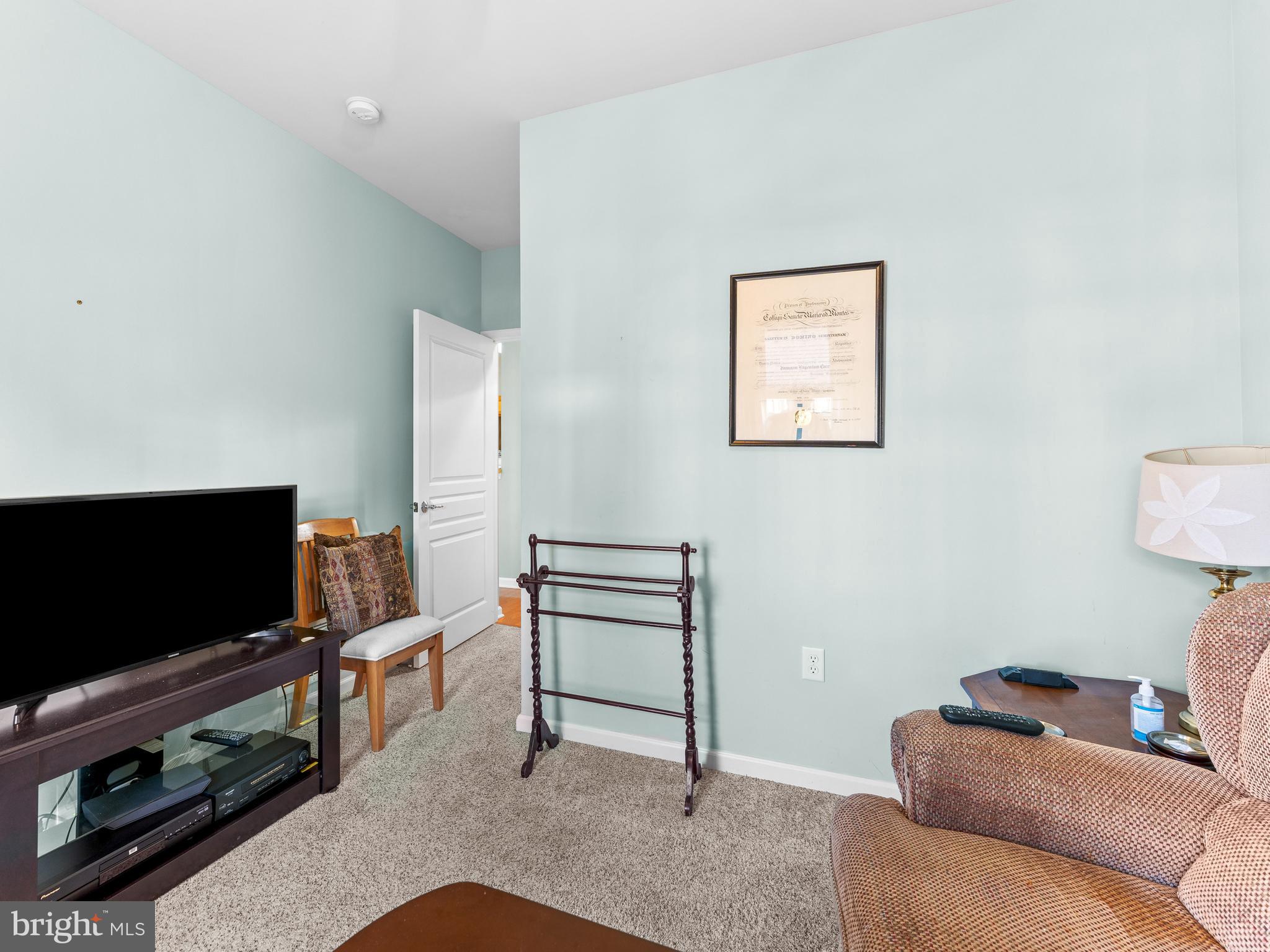522 Creekside Drive Brookhaven, PA 19015 - Photo 14 of 28 a living room with furniture and a flat screen tv