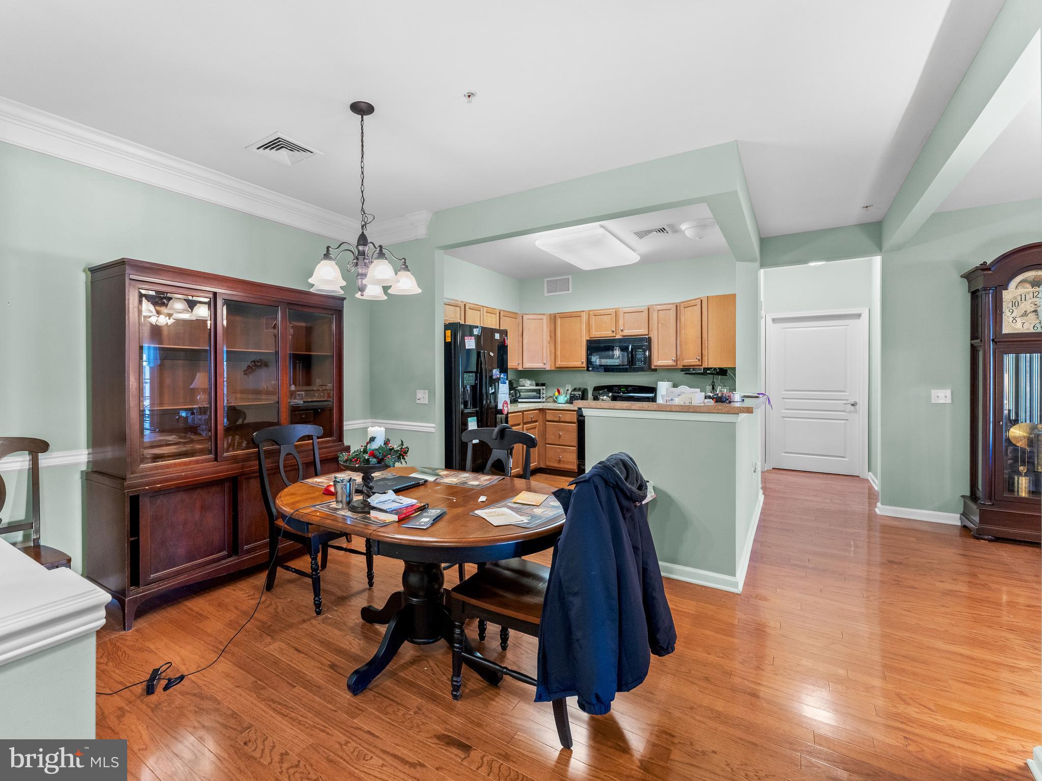 522 Creekside Drive Brookhaven, PA 19015 - Photo 2 of 28 a dining room with furniture a chandelier and wooden floor