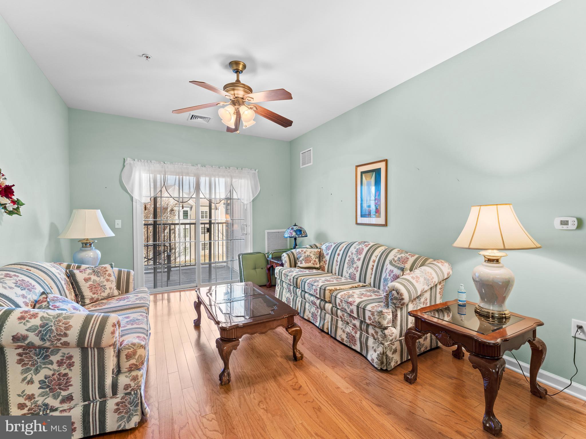 522 Creekside Drive Brookhaven, PA 19015 - Photo 7 of 28 a living room with furniture a table and a large window