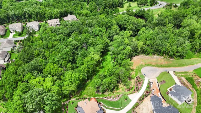 an aerial view of a house with a yard swimming pool and outdoor seating