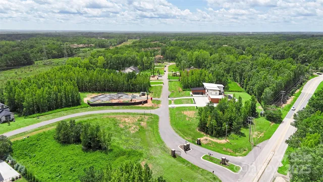 a backyard of a house with a yard and outdoor seating