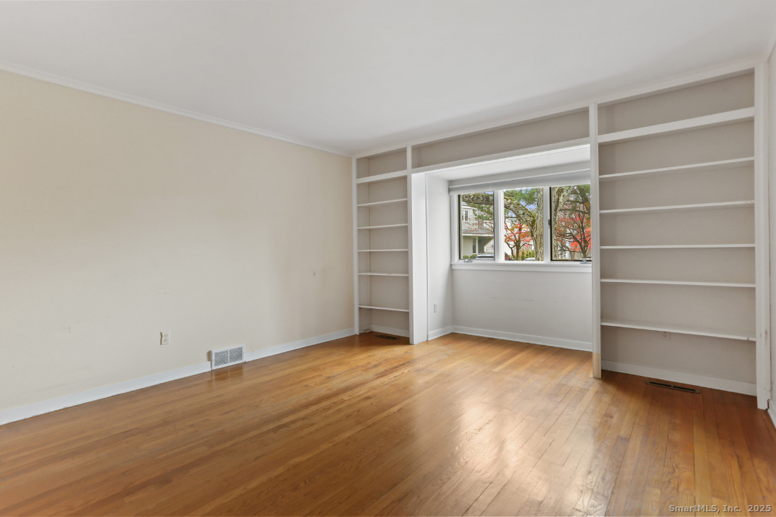 97 Field Point Drive, Unit 97 Fairfield, CT 06824 - Photo 15 of 40 wooden floor in an empty room with a window