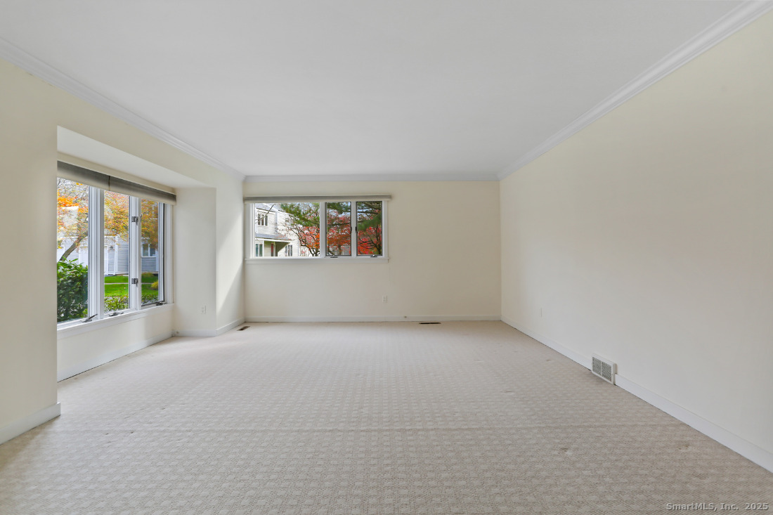 97 Field Point Drive, Unit 97 Fairfield, CT 06824 - Photo 9 of 40 an empty room with windows