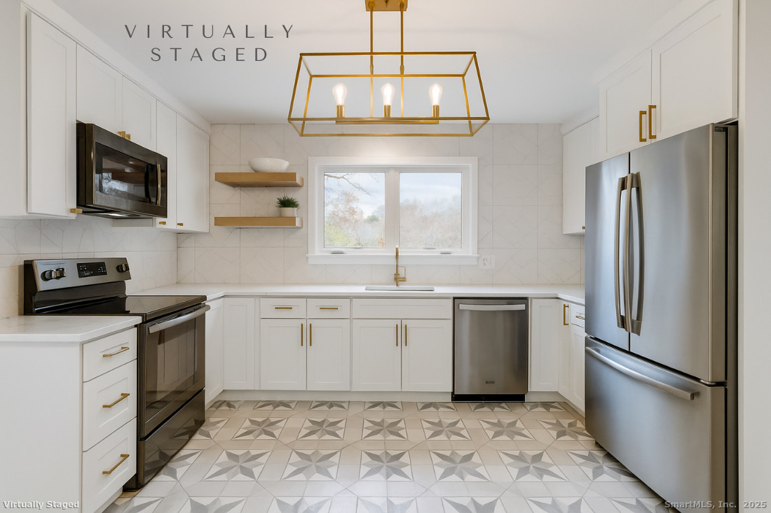 97 Field Point Drive, Unit 97 Fairfield, CT 06824 - Photo 10 of 40 a kitchen with a refrigerator sink and microwave