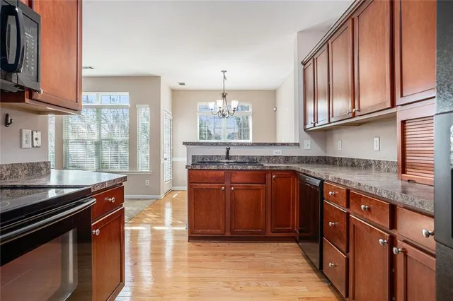 a kitchen with granite countertop a stove cabinets and a counter top space