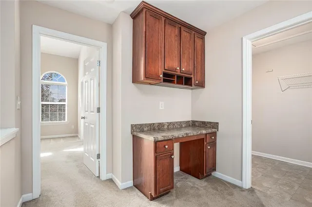 a room with a stove and a microwave