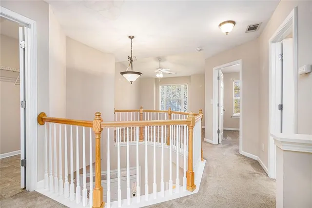 a view of a hallway with windows and entryway