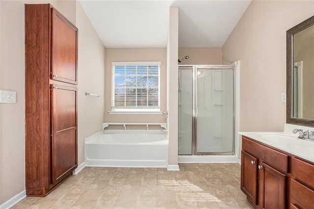 a bathroom with a tub sink and a mirror