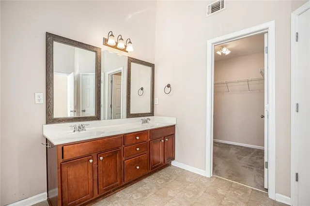 a bathroom with a double vanity sink and a mirror
