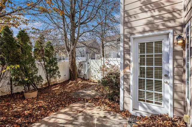 a view of a brick house with a large tree