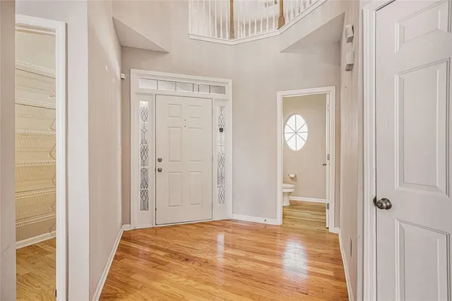 a view of a livingroom with wooden floor and closet area