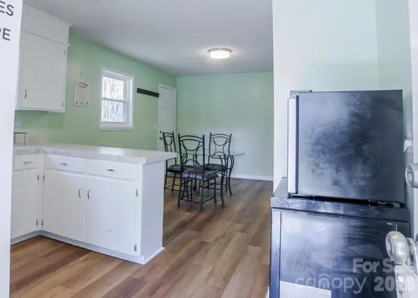an entryway with wooden floor and cabinet