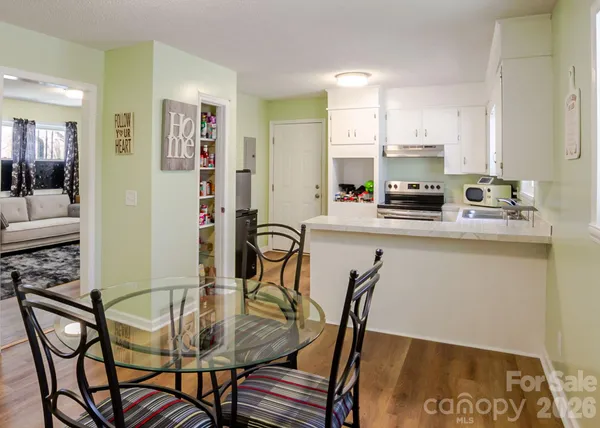 a view of a dining room with furniture and a rug