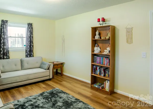 a living room with furniture and a book shelf