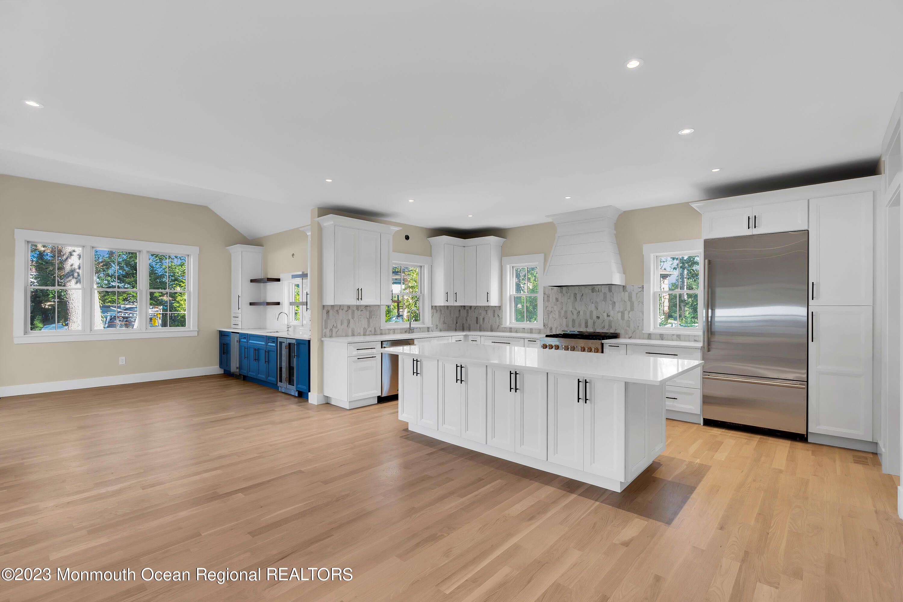 556 Church Street Spring Lake Heights, NJ 07762 - Photo 16 of 85 a large kitchen with stainless steel appliances granite countertop a stove a sink dishwasher a refrigerator and white cabinets with wooden floor