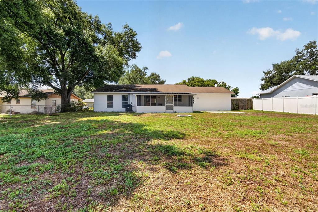 2340 Merrily Circle South Seffner, FL 33584 - Photo 46 of 52 a white house with a big yard and large trees