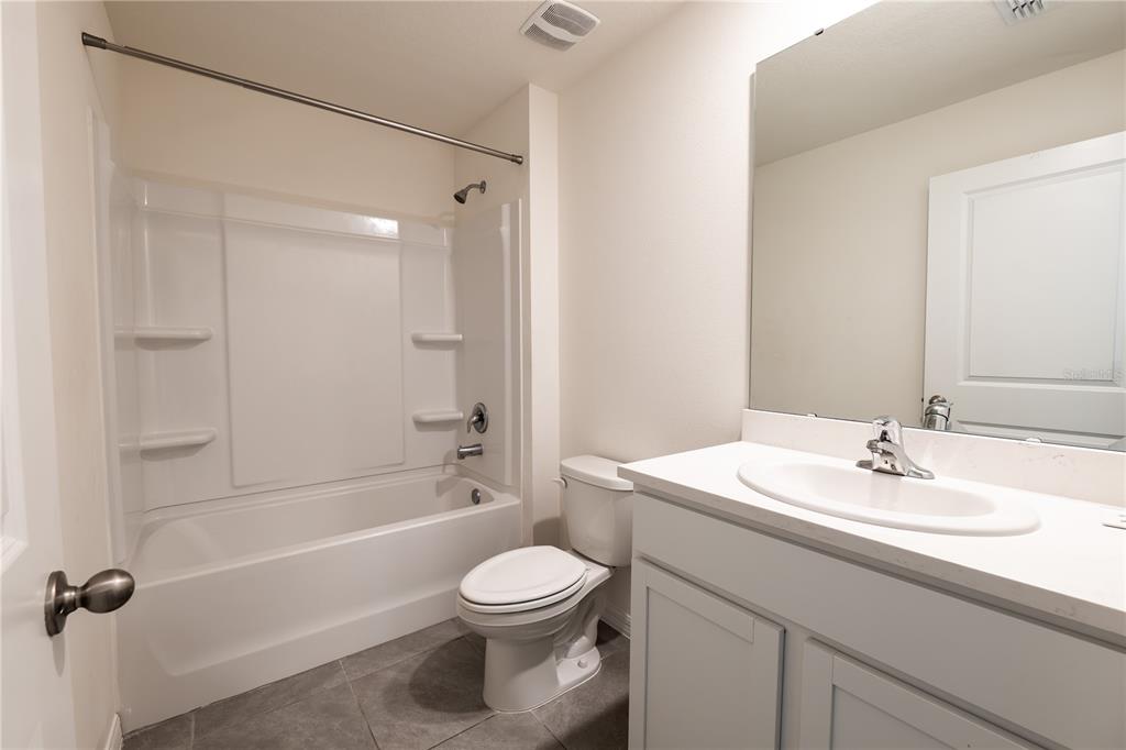 11272 Southeast 67th Circle Belleview, FL 34420 - Photo 11 of 24 a bathroom with a sink a toilet and shower