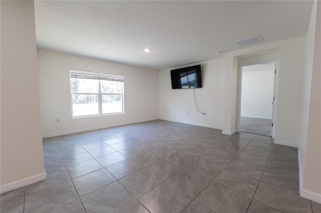 11272 Southeast 67th Circle Belleview, FL 34420 - Photo 14 of 24 a view of an empty room with a window