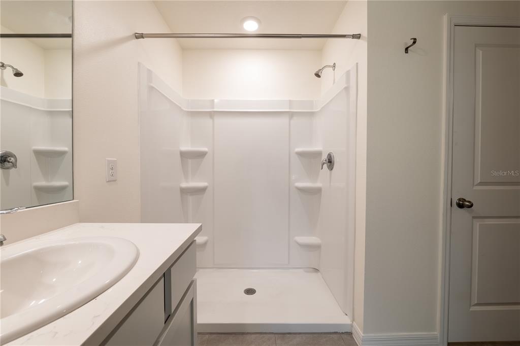 11272 Southeast 67th Circle Belleview, FL 34420 - Photo 17 of 24 a bathroom with a shower and a bath tub