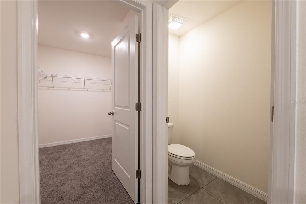 11272 Southeast 67th Circle Belleview, FL 34420 - Photo 18 of 24 a bathroom with a granite countertop toilet and a shower