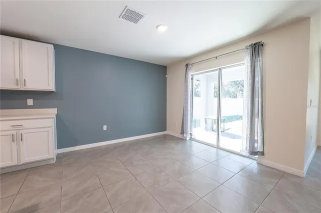a view of an empty room with a kitchen