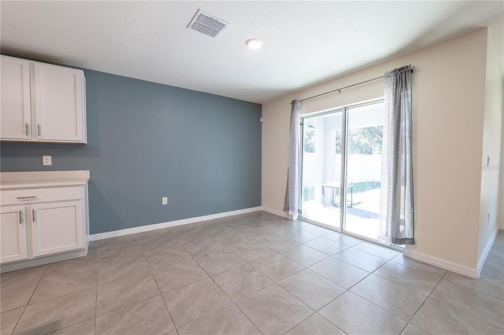 11272 Southeast 67th Circle Belleview, FL 34420 - Photo 5 of 24 a view of an empty room with a kitchen