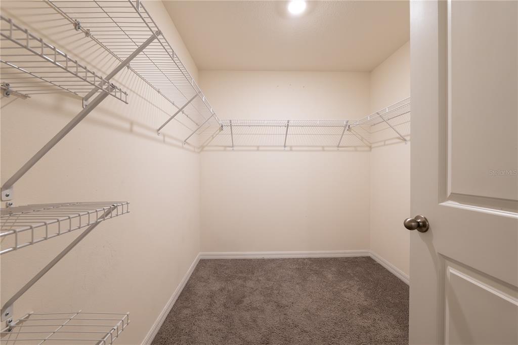 11272 Southeast 67th Circle Belleview, FL 34420 - Photo 9 of 24 a view of a room with racks on the wall