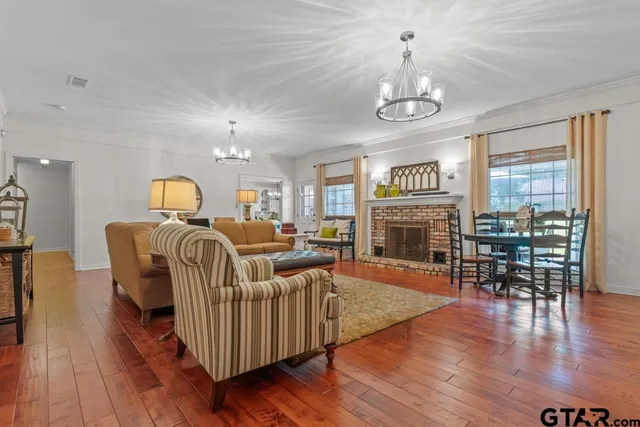 a living room with furniture dining table and a fireplace
