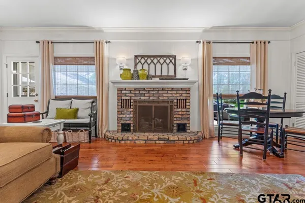 a living room with furniture wooden floor and a fireplace