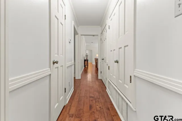 a view of a hallway with a wooden floor
