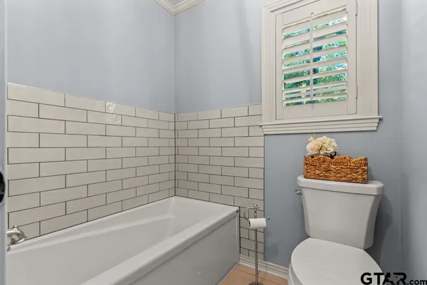 a bathroom with a toilet a sink and bathtub