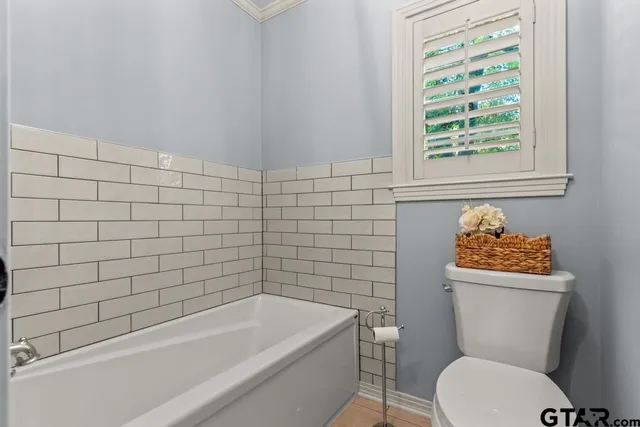 a bathroom with a toilet a sink and bathtub