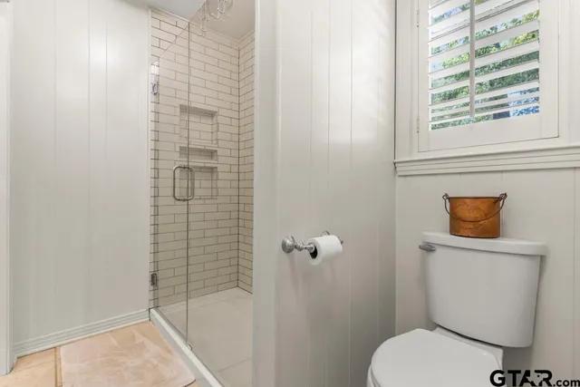 a bathroom with a shower and a sink