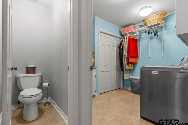 a view of a house with a big yard and large trees