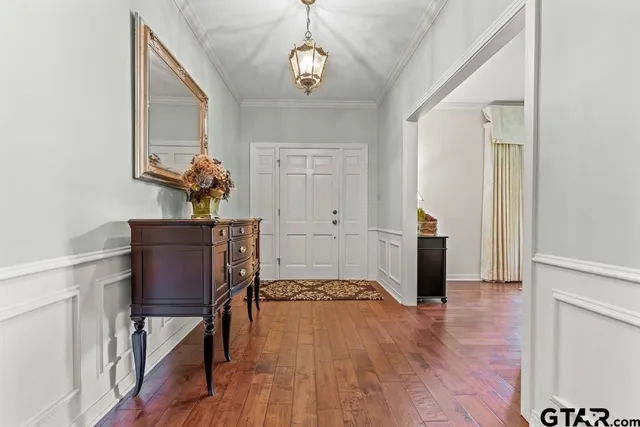 a view of hallway with furniture and wooden floor