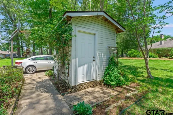 a view of house with a garden