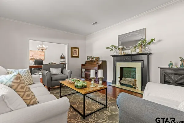 a living room with furniture a fireplace and a table