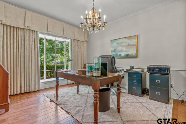 a view of a workspace with furniture and a window